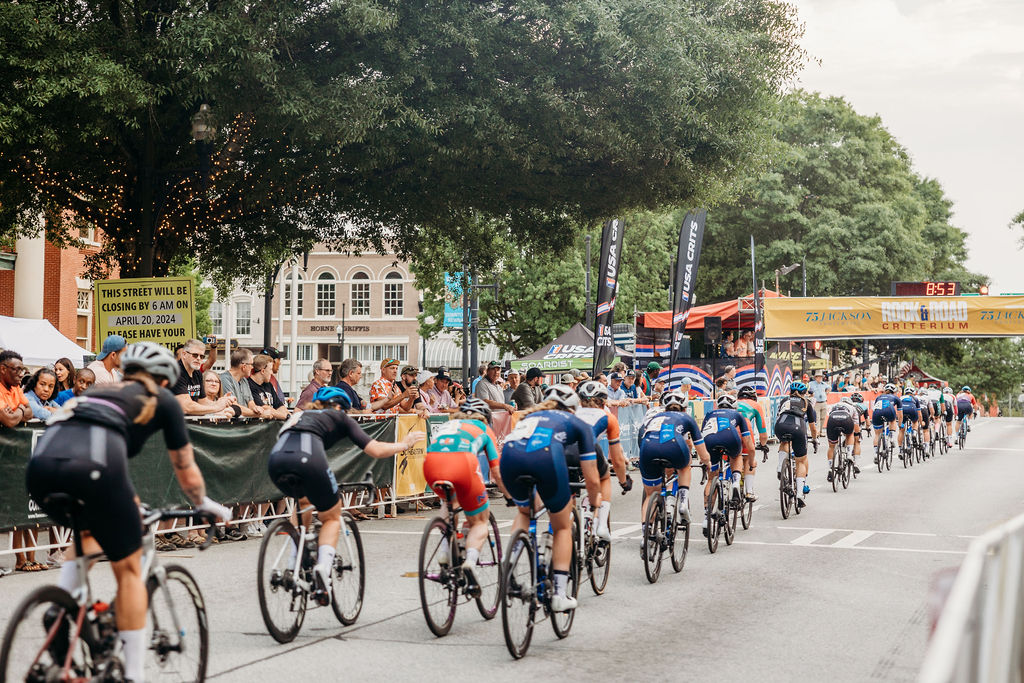 Cyclist riding in race to finish line on downtown street