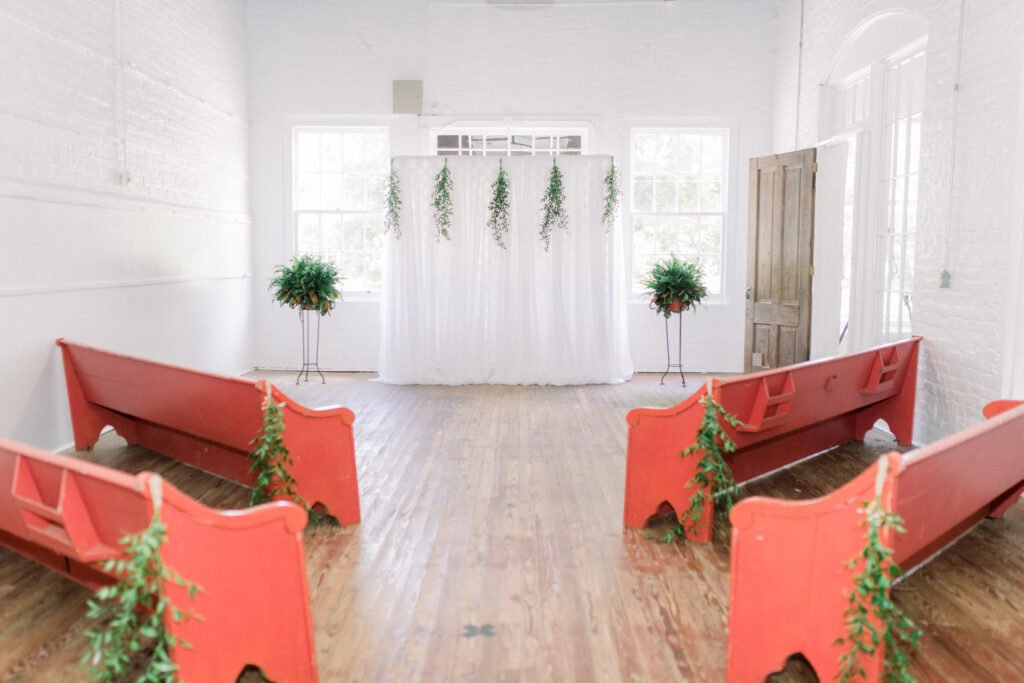 Red pews inside Old Moreland Mill
